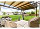 Relaxing outdoor patio with shade covering, a patio set, and a view of the backyard at 8141 Maple Stream Ln, Indianapolis, IN 46217
