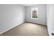 Neutral bedroom with soft carpeting, window view, and ample space at 8146 Whitaker Valley Blvd, Indianapolis, IN 46237