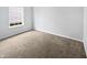Cozy bedroom with plush carpeting, window view, and neutral walls at 8146 Whitaker Valley Blvd, Indianapolis, IN 46237
