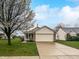 Charming single-story home with a two-car garage and a well-maintained front yard with a beautiful tree at 8146 Whitaker Valley Blvd, Indianapolis, IN 46237