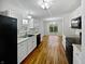 Bright kitchen with white cabinets, black appliances, and wood-look flooring at 8146 Whitaker Valley Blvd, Indianapolis, IN 46237