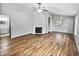 Open living room with hardwood floors, a fireplace, and ample natural light at 8146 Whitaker Valley Blvd, Indianapolis, IN 46237