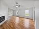 Bright living room with hardwood floors, fireplace, and a ceiling fan with natural lighting at 8146 Whitaker Valley Blvd, Indianapolis, IN 46237