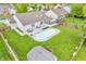 Aerial view showcasing large backyard with swimming pool, patio, and lush green lawn at 8375 Eagles Nest Dr, Avon, IN 46123