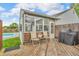 Cozy back deck with seating, grill, and view of screened in porch and fenced yard with pool at 8375 Eagles Nest Dr, Avon, IN 46123