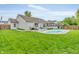A backyard oasis with a private pool, patio seating area, and a charming sunroom at 8375 Eagles Nest Dr, Avon, IN 46123