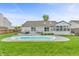 A backyard oasis with a refreshing pool, lounge seating, and a charming sunroom at 8375 Eagles Nest Dr, Avon, IN 46123