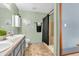 Well-lit bathroom featuring a dual sink vanity, shower with black curtain, and neutral wall color at 8375 Eagles Nest Dr, Avon, IN 46123