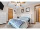 Bright bedroom featuring a bed with blue striped blanket, ceiling fan, and natural light at 8375 Eagles Nest Dr, Avon, IN 46123