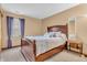 Cozy bedroom with a wooden bed frame, plush pillows, and a window with natural light at 8375 Eagles Nest Dr, Avon, IN 46123