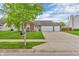 Charming brick home with a large driveway, three-car garage, and well-manicured lawn at 8375 Eagles Nest Dr, Avon, IN 46123