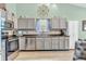 Well-equipped kitchen featuring stainless steel appliances, plenty of cabinets, and wood-look flooring at 8375 Eagles Nest Dr, Avon, IN 46123