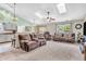 Open-concept living room with skylights, comfortable seating, and a partial view of kitchen at 8375 Eagles Nest Dr, Avon, IN 46123