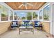 Enclosed sunroom with a ceiling fan, wood paneling, and plenty of natural light at 8375 Eagles Nest Dr, Avon, IN 46123