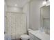 This bathroom features a vanity with solid surface counters and a shower with floral shower curtain at 8593 Hudson Way, Brownsburg, IN 46112