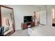 Bright bedroom featuring a large mirror, comfortable furnishings, and a view of the ensuite bathroom at 8593 Hudson Way, Brownsburg, IN 46112