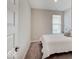 This bedroom features a plush bed, neutral walls, and natural light from a large window at 8593 Hudson Way, Brownsburg, IN 46112