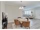 Cozy dining area leads to a living room, both featuring natural light and neutral tones at 8593 Hudson Way, Brownsburg, IN 46112