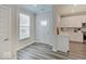 Welcoming entryway with a bright front door and modern flooring next to the eat-in kitchen area at 8593 Hudson Way, Brownsburg, IN 46112