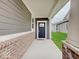 Inviting covered entry features a dark front door, brick accents, and a 'hello' doormat at 8593 Hudson Way, Brownsburg, IN 46112