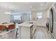 Open-concept kitchen with stainless steel appliances and a large island seamlessly connects to the living area at 8593 Hudson Way, Brownsburg, IN 46112