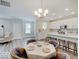 Eat-in kitchen featuring a dining table, an island with barstool seating, and modern white cabinets at 8593 Hudson Way, Brownsburg, IN 46112