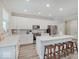 Modern kitchen features white cabinets, quartz countertops, stainless steel appliances, and a center island at 8593 Hudson Way, Brownsburg, IN 46112