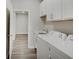 This laundry room features white shaker cabinets, a sink, and modern appliances at 8593 Hudson Way, Brownsburg, IN 46112