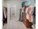 Large walk-in closet featuring ample hanging space, shelving, and a glimpse into another room at 8593 Hudson Way, Brownsburg, IN 46112