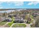 Stunning aerial view of property, showcasing the home, landscaping, and lake in the background at 9719 Decatur Dr, Indianapolis, IN 46256