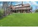 Expansive backyard showing the home's brick exterior, a multi-level deck, and a well-kept lawn at 9719 Decatur Dr, Indianapolis, IN 46256