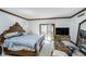 Bedroom featuring carpeted floors, wood trim and access to balcony at 9719 Decatur Dr, Indianapolis, IN 46256