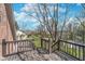 Wooden deck with railing overlooks the landscaped backyard and neighborhood beyond at 9719 Decatur Dr, Indianapolis, IN 46256