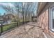 Spacious wooden deck, great for outdoor entertaining, with brick exterior and railing at 9719 Decatur Dr, Indianapolis, IN 46256