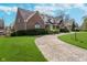 Brick home showing curving driveway and lush landscaping at 9719 Decatur Dr, Indianapolis, IN 46256