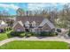 Aerial shot of a brick home with well-maintained landscaping and a circular driveway at 9719 Decatur Dr, Indianapolis, IN 46256