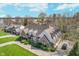 Aerial view of brick home with manicured lawn and circular driveway on a sunny day at 9719 Decatur Dr, Indianapolis, IN 46256