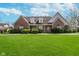 Charming brick home featuring a well-manicured lawn and classic architectural details at 9719 Decatur Dr, Indianapolis, IN 46256