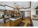 Bright kitchen featuring an island cooktop, stainless steel appliances, and hardwood floors for a modern, functional design at 9719 Decatur Dr, Indianapolis, IN 46256
