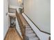Carpeted staircase with wooden banister and trim at 9719 Decatur Dr, Indianapolis, IN 46256