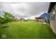 Expansive backyard featuring a lush lawn, mature trees, playground, and charming covered patio area for outdoor relaxation at 9949 Stable Stone Ter, Fishers, IN 46040