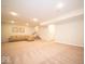 Large finished basement with soft carpeting, a cozy sofa, and a staircase leading to the upper level at 9949 Stable Stone Ter, Fishers, IN 46040