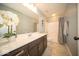 Well-lit bathroom with a modern single sink vanity, toilet, shower with tub, and stylish tile flooring at 9949 Stable Stone Ter, Fishers, IN 46040