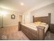 This bedroom is finished with modern style from the hard wood bed frame, carpeted floors, and great natural light at 9949 Stable Stone Ter, Fishers, IN 46040