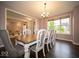 Elegant dining room with hardwood floors, large windows, and a six-chair dining set at 9949 Stable Stone Ter, Fishers, IN 46040