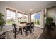 Light-filled dining area with backyard views, neutral wall paint, and stylish contemporary decor at 9949 Stable Stone Ter, Fishers, IN 46040
