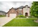 Stunning two-story brick home featuring a spacious front yard with a long driveway at 9949 Stable Stone Ter, Fishers, IN 46040
