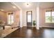 Bright foyer with hardwood floors and a chair for seating near the entrance at 9949 Stable Stone Ter, Fishers, IN 46040