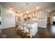 Spacious kitchen with a large island, stainless steel appliances, modern lighting, and luxury vinyl flooring at 9949 Stable Stone Ter, Fishers, IN 46040