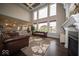 Open-concept living room with a fireplace and a glimpse of the kitchen in the background at 9949 Stable Stone Ter, Fishers, IN 46040